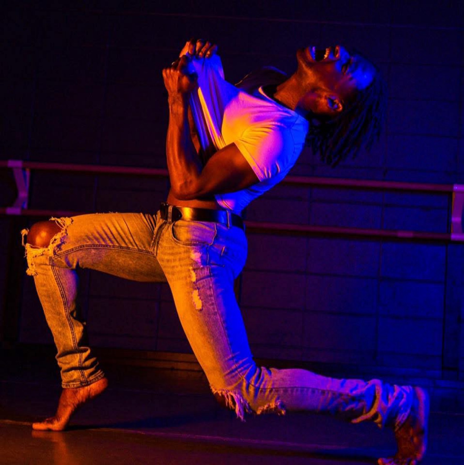 Justin in dynamic performance under dramatic lighting